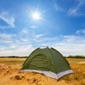 small green touristic tent among sandy prairie