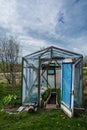 Small greenhouse with doors opened in a garden in spring at day Royalty Free Stock Photo