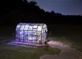 Small greenhouse well lit after the stars are out Royalty Free Stock Photo