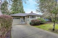 Small grey home exterior with a garage