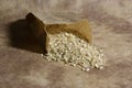 Small bag of grocer`s paper with barley and spelled rice grains Royalty Free Stock Photo