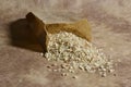 Small bag of grocer`s paper with barley and spelled rice grains Royalty Free Stock Photo