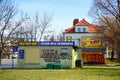 Small grocery store with graffiti and clean green grass.