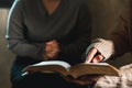 Small group of asian people praying worship believe. Teams of friends worship together before studying Holy bible. family praying Royalty Free Stock Photo