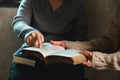 Small group of asian people praying worship believe. Teams of friends worship together before studying Holy bible. family praying Royalty Free Stock Photo