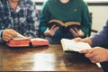 Small group of asian people praying worship believe. Teams of friends worship together before studying Holy bible. family praying Royalty Free Stock Photo