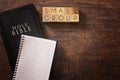 Small Group in Block Letters on a Wooden Table with a Holy Bible