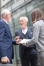 Small group of business people meeting in the street outside of an office building, looking at sales reports Royalty Free Stock Photo