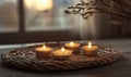 A small group of candles are lit on a wicker tray Royalty Free Stock Photo