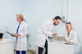 Small group of doctors working together in doctor`s office. Royalty Free Stock Photo