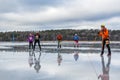 Small group of ice skaters on wet and watery ice. Royalty Free Stock Photo