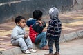 A small group of poor children sitting on footpath during cold weather in India. Indian