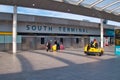 A small group of travellers at a largely deserted Gatwick Airport South Terminal, taken during the coronavirus health emergency