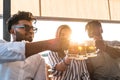 small group of young adult multiethnic friends toasting with three mugs of beer Royalty Free Stock Photo