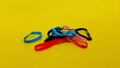 Small hair tie bands are colorful and unique on yellow background.