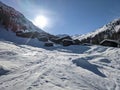 a small hamlet in winter above the small village of monstein in davos. Sunny winter morning landscape with mountains. Royalty Free Stock Photo