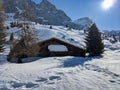 a small hut in winter above the small village of Sankt Antonien in Partnun. Sunny winter morning landscape with mountain Royalty Free Stock Photo