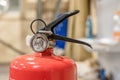 Small hand-held fire extinguisher with pressure gauge in a locksmith`s shop Royalty Free Stock Photo