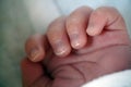 Small hand of newborn baby kid child. Fingers with nails. close up view macro Royalty Free Stock Photo