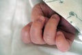 Small hand of newborn baby kid child. Fingers with nails. close up view macro Royalty Free Stock Photo