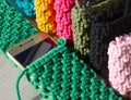 Small handbag for a mobile phone. Knitting macrame, pattern of multi-colored cotton cords. Handmade concept, hobby Royalty Free Stock Photo