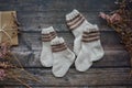 Small handmade baby socks on dark wooden background