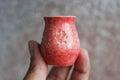 Small handmade red clay with cat paws pot for making wishes or flowers from boutonnieres. Decor engobe, covered with transparent