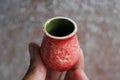 Small handmade red clay with cat paws pot for making wishes or flowers from boutonnieres. Decor engobe, covered with transparent