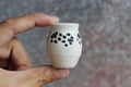 Small handmade white clay with cat paws pot for making wishes or flowers from boutonnieres. Decor engobe, covered with transparent