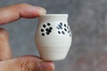 Small handmade white clay with cat paws pot for making wishes or flowers from boutonnieres. Decor engobe, covered with transparent