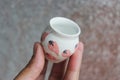 Small handmade white clay pot for making wishes or flowers from boutonnieres. Decor engobe, covered with transparent glaze, two