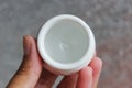 Small handmade white clay pot for making wishes or flowers from boutonnieres. Decor engobe, covered with transparent glaze, two