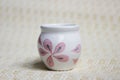Small handmade white clay pot for making wishes or flowers from boutonnieres. Decor engobe, covered with transparent glaze, two