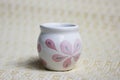 Small handmade white clay pot for making wishes or flowers from boutonnieres. Decor engobe, covered with transparent glaze, two