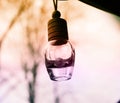 Small hanging bottle with orange and purple tones