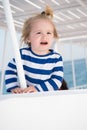 Small happy baby boy on yacht in marine shirt, fashion Royalty Free Stock Photo