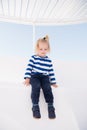 Small happy baby boy on yacht in marine shirt, fashion