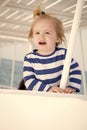 Small happy baby boy on yacht in marine shirt, fashion Royalty Free Stock Photo