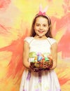 Small happy baby girl holding pottle with easter eggs