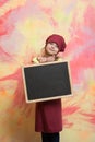 Small happy girl chef in hat, apron with blackboard Royalty Free Stock Photo