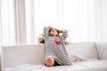 A small happy girl in striped T-shirt at home having fun. Royalty Free Stock Photo