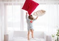 A small happy girl in striped T-shirt at home having fun. Royalty Free Stock Photo