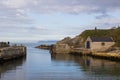 The small harbor at Ballintoy on the North Antrim Coast of Northern Ireland with its stone built boathouse on a day in spring