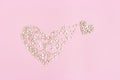 Small heart emerges from large one. Birth of new love. Concept of love. Many small wooden hearts on pink Royalty Free Stock Photo