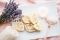 Small heart and leaf shape bath truffles and rose quartz face rolling tool. Home spa.