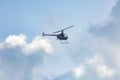 A small helicopter flies through the cloudy sky Royalty Free Stock Photo