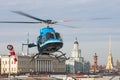 Small helicopter takes off from the helipad in St. Petersburg, against the backdrop of the Kunstkamera, the arrow of the Vasilyevs