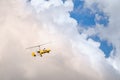 Small helicopter for two person flying on the cloudy sky Royalty Free Stock Photo