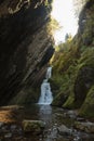 Small hidden waterfall in the forest in the cleft of the rock Royalty Free Stock Photo