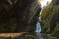 Small hidden waterfall in the forest in the cleft of the rock Royalty Free Stock Photo